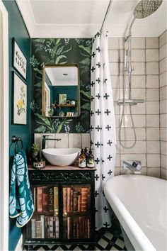 a bathroom with a sink, mirror and bathtub next to a bookcase filled with books