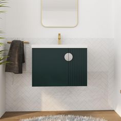 a white bathroom with a green cabinet and mirror