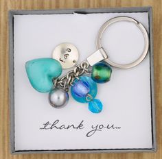 a card with a keychain and some beads on it that says thank you