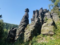 some very tall rock formations in the woods