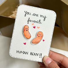 someone holding up a card that says you are my favorite human bean