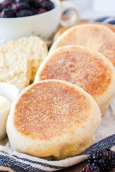 three pancakes on a plate with berries and butter next to it, along with other ingredients