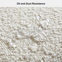 an image of oil and dust resistance on the carpet with water drops coming from it