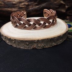 Copper Adjustable Braided Wide Cuff Bracelet. Made of Several Intertwined Copper Rods.  This Bracelet is A Modern Version of the Bracelets of the Northern Peoples of the Middle Ages. Copper is used to Relieve Osteoarthritis and Rheumatic Pain thanks to Its Anti-Rheumatic and Anti-Inflammatory Properties. Its  Sober Style is suitable for both Men and Women. You Can Adjust This Bracelet Directly On Your Arm Because It Is Flexible And Open at the Back. -Material: Brass -Color:  Copper -Style: Cuff -Diameter 7 cm - Opening width: 3 cm -Width: 1.5 cm -Thickness: 1 mm Handmade Delivered in a Fabric Pouch Ideal for Gifting To offer or simply treat yourself, do not hesitate! *◅ ↠ ☽ ◅* *▻ ☾  ↠ You Might Also Like This Others Bracelets: https://www.etsy.com/fr/listing/1636159515/bracelet-en-cuivre-t Bohemian Braided Bangle Jewelry, Adjustable Braided Bangle Jewelry, Spiritual Braided Bracelet Jewelry, Adjustable Braided Cuff Bracelet, Braided Metal Bracelets As Gift, Bohemian Braided Metal Bracelets As Gift, Adjustable Braided Metal Bracelets, Bohemian Braided Bracelet Jewelry, Adjustable Medieval Bangle Cuff Bracelet