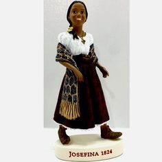 a figurine of a woman wearing a brown dress and white shirt with the name josefina on it