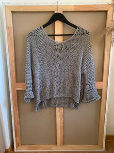 a sweater hanging on a wooden hanger