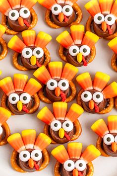 turkey pretzels with chocolate frosting and candy eyes are arranged on a plate