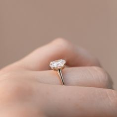 Details Metal 14K Gold Center Stone 8x5, 10x6, and 12x8mm Elongated Oval Forever One Colorless Moissanite - Charles & Colvard *For diamond options please contact us. Pictured: 10x6mm Moissanite in Rose Gold 8x5mm Moissanite in Rose Gold 10x6mm Moissanite in Yellow Gold 8x5mm Moissanite in Yellow Gold 12x8mm Moissanite in Rose Gold Customization Want to change this design or don't see what you want? We can customize most existing designs or custom make a ring from scratch. Please contact us w Delicate 14k Gold Solitaire Wedding Ring, Delicate Solitaire Wedding Ring In 14k Gold, Delicate Oval Solitaire Jewelry, Delicate Oval Jewelry With Brilliant Cut, Delicate Oval Ring With Center Stone, Refined 14k Gold Solitaire Wedding Ring, Oval Single Diamond Jewelry For Wedding, Delicate Oval Solitaire Ring, Delicate Oval Ring With Single Diamond