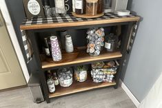 the shelves are filled with different types of coffee and condiments on top of them