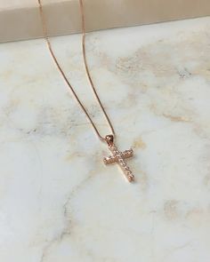 This very delicate rose gold cross necklace is the perfect gift for your confirmand. The cross is 18k gold filled with beautiful CZ'S strung on a delicate 18k gold chain. Chain Length Measures 17 1/2" Rose Gold Cubic Zirconia Cross Pendant, Rose Gold Cubic Zirconia Cross Necklace, Delicate Rose Gold Cross Jewelry, Elegant Rose Gold Crucifix Cross Necklace, Rose Gold Cross Pendant Jewelry With Delicate Chain, Rose Gold Cross Pendant With Delicate Chain, Rose Gold Cross Jewelry With Adjustable Chain, Rose Gold Clavicle Chain Cross Jewelry, Rose Gold Jewelry With Delicate Chain And Cross Pendant