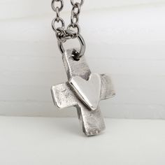 Express your faith and love with this cute handmade 925 sterling silver cross necklace featuring an original and unique design. Its highly polished heart on a vintage patina style cross adds a beautiful, meaningful touch. Perfect for a young girl's Confirmation, First Communion, or a special Valentine's or Christmas gift! The pendant hangs on a lovely 925 sterling silver chain. Gift Sterling Silver Cross Necklace With Oxidized Finish, Gift Cross Necklace With Oxidized Finish, Gift Oxidized Cross Pendant Necklace, Oxidized Cross Pendant Necklace For Gift, Oxidized Cross Necklace As Gift, Oxidized Finish Cross Necklace As Gift, Oxidized Finish Cross Necklace For Gifts, Patina Style, Sterling Silver Cross Necklace