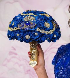 a woman holding a blue bridal bouquet