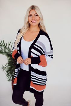 Cozy knit cardigan with pockets and an oversized fit. Stripe colors are black, white, grey, and pumpkin orange. Model Specs: ﻿ Kendra is 5'5", 34DD, Size 5, Wearing size Small Fabric: Sizing Recommendations: Small 0/4 Medium 6/8 Large 10/12 Maxi Romper, Cardigan With Pockets, Cozy Knit, Short Sleeve Bodysuit, Striped Cardigan, Pumpkin Orange, Dark Wash Denim, Cozy Knits, Shoes Booties