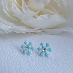 Beautiful and dainty pair of snowflake stud earrings in baby blue with shiny Cubic Zirconia in 925 high quality sterling silver. Earrings are perfect for any age. Metal : 925 Sterling Silver. ( 925 stamped ) Measurements : 8mm x 8mm. Gemstone: Cubic Zirconia. These delicate stud earrings are handcrafted from 925 sterling silver, that doesn't tarnish their little ears, hypoallergenic, nickel and lead free. ADD TO YOUR ORDER: 925 Sterling silver butterfly silicone coated backings link:  https://ww Light Blue Flower Shaped Jewelry Gift, Light Blue Flower-shaped Jewelry For Gifts, Cute Silver Flower Shaped Earrings, Blue Earrings For Christmas Gift, Cute Hypoallergenic Silver Flower Earrings, Cute Silver Flower Earrings For Gift, Cute Silver Flower Earrings As Gift, Light Blue Flower Shaped Earrings For Gift, Cute Light Blue Earrings Gift