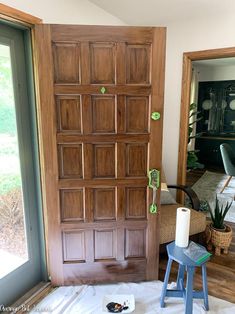 a wooden door with some green stickers on it and a blue stool in front of it