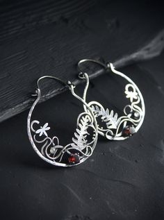 ITEM DESCRIPTION: Size H 6 x W 4 cm (2 1/2 x 1 1/2 inches) with closure. Wire earrings are very lightweight and comfortable for your ears. Weight - 5 g of each other. These unique circle earrings look like a piece of wild magic forest with fern leaves and dragonflies. I made them of sterling silver, natural garnet, and tiny labradorite. Statement botanical earrings will come to you in a gift box - ready for gifting. You can order these unique hoop earrings this different stones. Please write to Silver Nature-inspired Hoop Earrings As Gift, Silver Nature-inspired Hoop Earrings For Gift, Handmade Nature-inspired Hoop Earrings, Handmade Nature-inspired Round Hoop Earrings, Handmade Small Hoop Earrings, Nature-inspired, Handmade Small Hoop Earrings Nature-inspired, Nature-inspired Dangle Hoop Earrings As Gift, Nature-inspired Dangle Hoop Earrings, Nature-inspired Dangle Hoop Earrings For Gift