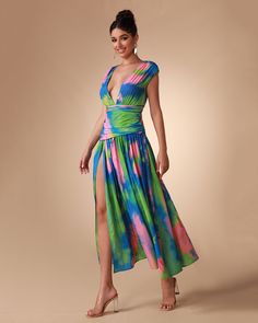 a woman in a colorful dress posing for the camera