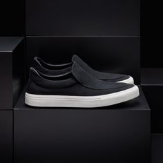 Our Coastal Canvas Slip On is made of cotton canvas with vulcanized rubber sole, adding flexibility and stability to this classic shoe. Additional Information:• 100% Cotton • Leather lining, removable sole • Imported Modern Black Slip-ons With Rubber Sole, Modern Textured Sole Slip-ons For Streetwear, Modern High-top Slip-on Sneakers With Vulcanized Sole, Modern Black Slip-ons With Contrast Sole, Slip-on Sneakers With Textured Sole For Streetwear, Canvas Slip-on Sneakers With Branded Insole, Canvas Slip-on Sneakers With Branded Insole And Round Toe, Canvas Skate Shoes With Textured Sole And Round Toe, Canvas Skate Shoes With Textured Sole