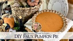 a pumpkin pie sitting on top of a table next to other dishes and decor items