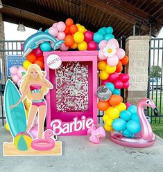 there is a barbie beach themed party with balloons and decorations on the side of the building