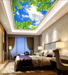 the ceiling is decorated with birds flying in the blue sky and white clouds above it