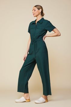 If you need an outfit that will have you ready in 30 seconds, opt for this utility jumpsuit. It's basically effortless, designed with short sleeves, multiple pockets, and a drawstring waist to define the shape. •Pointed collar •Buttoned half placket •Utility pockets •Elasticized waist •Adjustable drawstring Item Number: 74374 Jumpsuit Outfit Aesthetic, Coverall Outfit Women, Utility Jumpsuit Outfit, Modest Jumpsuit, Green Jumpsuit Outfit, Dark Green Jumpsuit, Fall Outfit Inspo Aesthetic, Jumpsuit Uniform, Wife Outfits