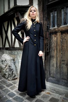 This black coat, made in a beautiful black wool inspired by Victorian fashion, is ideal for winter! Lined with cotton, it closes with its 5 brass-plated buttons. Officer collar, gigot sleeves, waistband at the back. Dry cleaning recommended. Ironing allowed at low temperature. Original handmade creation, in France by Telos. Fall Cosplay Outerwear With Button Closure, Winter Cosplay Outerwear With Buttons, Cosplay Long Coat With Buttons, Winter Costume Double-breasted Outerwear, Winter Cosplay Outerwear With Button Closure, Long Black Outerwear With Buttons, Wool Long Sleeve Outerwear For Costumes, Gothic Long Coat With Buttons, Gothic Winter Outerwear With Buttons