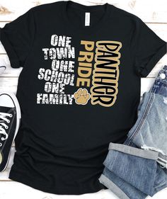 a t - shirt with the words, one town two tone pride and paw family on it