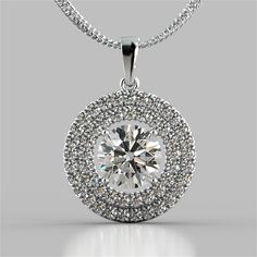 Decorate any look with this impressive pendant. Gleaming simulated diamonds are the perfect addition to your ensemble. A divine double tier halo delicately holds the ravishing center stone. Pendant features a bail slide that always sits flush on your dcollet. Add some luster to your collection today. 2.75CT Round Cut Double Pave Style Halo Pendant;  Center Stone: 2.0 CT Agape Simulated Diamond;  Total Carat Weight: 2.75 CTW;  Available in: 14K White Gold;  16" 14K White Gold Chain Included;  Mod Luxury Elegant Gemstones With Halo Setting, Luxury Sterling Silver Diamond Necklace With Halo, Luxury Halo Fine Jewelry Necklace, Exquisite Luxury Round Pendant Jewelry, Luxury Medallion-shaped Diamond Cut Jewelry, Luxury Medallion Shaped Diamond Cut Jewelry, Halo Cut, Memorable Jewelry, Halo Jewelry