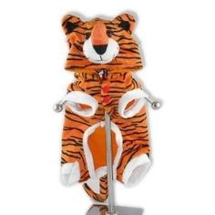 a stuffed tiger sitting on top of a metal stand