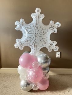 a bunch of balloons that are in the shape of a snowflake on carpet