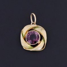 This charm features a purple glass doublet set in 10k gold, adorned with pale green enamel.  The charm was originally an antique stick pin (circa 1900) that our jeweler transformed by removing the pin stem and adding a jump ring bail.  The charm measures 0.75 inches from the top of the jump ring to bottom by 0.5 inches wide, and it is in great condition. We have many other fantastic offerings of antique and vintage jewelry posted on our Etsy store, so please consider browsing our other items. We Heirloom Enamel Jewelry Hallmarked, Antique Enamel Pendant Jewelry, Vintage Enamel Jewelry With Gemstone, Vintage Enamel Gemstone Jewelry, Antique Enamel Round Pendant Jewelry, Victorian Enamel Pendant Jewelry, Art Nouveau Yellow Gold Jewelry With 17 Jewels, Antique Enamel Charms Jewelry, Victorian Round Enamel Jewelry