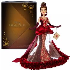 the doll is wearing a red dress and holding a purse in front of a box