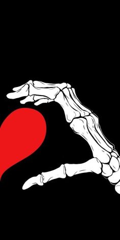 a hand holding a red heart on a black background