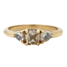 three stone ring in yellow gold with white diamonds on the sides and two smaller stones at the top