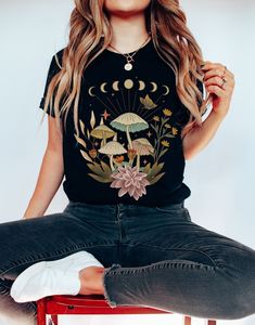 "Free shipping on all orders over $35! Check out the rest of our shop to see what else you'll love! www.etsy.com/shop/boldbirdapparel Get ready to be OBSESSED with your new Mushroom shirt! It's the cutest and most trendy way to emit all those important Forestcore vibes! This is the perfect Mushroom t-shirt! Great as a gift for anyone who loves the Cottagecore Aesthetic! Please reach out to us if your size is \"Out of Stock\" as your size may have become available recently! ⋆⋆ 𝑰𝑴𝑷𝑶𝑹𝑻𝑨𝑵𝑻 Library Fashion, Mushroom Tshirt, Mushroom Shirt, Neon Moon, Cottagecore Shirt, Witchy Fashion, Art Shirt, Gardening Shirts, Amazon Gadgets