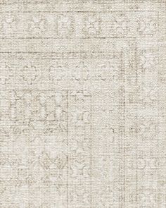 an old rug is shown in white and beige colors