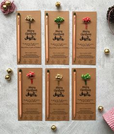 six christmas gift tags with pencils and ornaments around them on top of a table