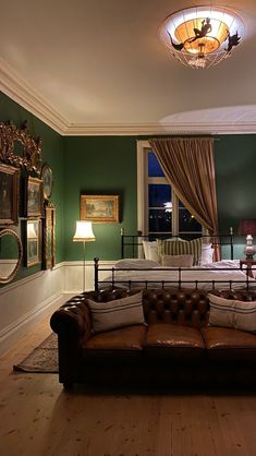 a living room filled with furniture and green walls