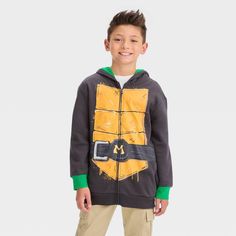 This Teenage Mutant Ninja Turtles Michelangelo Zip-Up Sweatshirt makes a fun, fanciful addition to your child's cool-weather wardrobe. The black sweatshirt is designed to look like Mikey's armor with a brown front, a belt, and an orange eye mask on the forehead flap of the attached hood. The ribbed trim on the long sleeves and below-waist hem provides a neat look, while the midweight cotton-blend construction helps keep them warm and toasty. Plus, the full-length zippered front makes it easy to Ninja Turtles Masks, Boys Teenage, Tmnt Clothes, Ninja Turtles Michelangelo, Teenage Mutant Ninja Turtles Merch, Ninja Turtle Shirt, Rise Of The Teenage Mutant Ninja Turtles Hoodie, Boy Hoodie, Navy Blue Sweatshirt