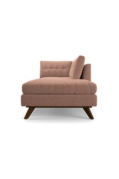 a pink couch sitting on top of a wooden frame