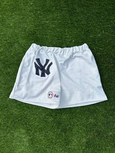 Custom made New York Yankees jersey shorts. Made from a Majestic New York Yankees jersey. Elastic band and two pockets added. Best fits waist sizes 30-36in.  THIS IS A 100% UPCYCLED PRODUCT I am self-taught and NOT a professional. Stitching errors or size issues are likely with a handmade product. If you have any questions or concerns about a product, please message me. Thank you for supporting a creator! Short Sports Bottoms With Pockets, Sport Event Bottoms With Built-in Shorts, Bottoms With Built-in Shorts For Sports Events, Sporty Bottoms With Built-in Shorts For Sports Events, Summer Sports Shorts With Letter Print, Summer Sports Event Shorts With Letter Print, Letter Print Shorts For Sports Events In Summer, Short Sports Bottoms With Letter Print, Casual Sports Bottoms With Pockets