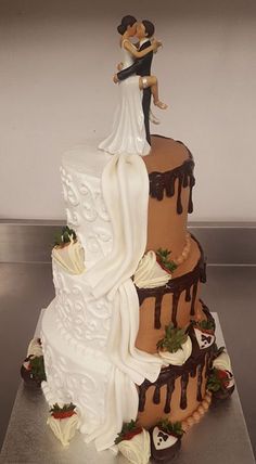 a wedding cake is decorated with chocolate and white frosting