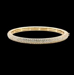 Add a touch of elegance to your jewelry collection with this stunning 18k yellow gold bangle bracelet. The bracelet features a beautiful round natural diamond set in a pavé style. The bracelet is 58mm in length from left to right inside and 54 mm top to bottom inside. Width: 5 mm Weight: 25 grams approx. may vary due to hand-made job. Total diamond weight: 3.10 tcw including 145 round diamond each approx. 1.7 mm Average clarity:VS2 Average color: G-H Comes in a nice gift box! Luxury Round Bangle With Pave Setting, Gold Cubic Zirconia Bracelet With Pave Setting, Yellow Gold Bangle With Pave Setting, Timeless Yellow Gold Bangle With Pave Setting, Yellow Gold Diamond Bangle With Pave Setting, Unique Bangle, Yellow Gold Bangle, Diamond Bangles Bracelet, Bracelet Online