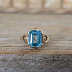 Vintage Art Deco Blue Teal Synthetic Spinel Ring in 10k Yellow Gold  Here is a spectacular vintage ring!  It is a lab grown spinel in gorgeous Carribean Blue Teal color. It is set into 10k yellow gold. Nice, substantial gold on this one.  MEASUREMENTS: Spinel-9 x 7.5mm Sits 5.11 mm high off the finger Band tapers to 1.4 mm in the back Weight -3.17 g Size -6.25 Hallmarks/Stamp - 10k  Condition -Very good commensurate with age. Tiniest rattle if you put up to your ear. Secure stone. Your item will arrive beautifully gift-boxed. Layaway is available. Click the tab above (or scroll down on your mobile device) for shop information, policies, and frequently asked questions. ✦ INSURANCE APPRAISAL~ Add to your order with this listing here: www.etsy.com/listing/268711436/gemologist-insurance-apprai Vintage Blue Open Ring, Vintage Turquoise Open Ring Adjustable, Antique Handmade Blue Turquoise Ring, Antique Handmade Turquoise Blue Ring, Vintage Adjustable Turquoise Cabochon Ring, Carribean Blue, Finger Band, Spinel Ring, Deco Blue