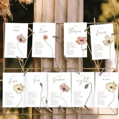 wedding seating cards hanging from a metal rack