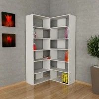 a white book shelf in the corner of a room next to a potted plant