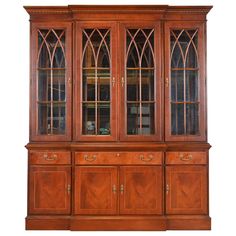 a wooden china cabinet with glass doors and drawers on the front, against a white background