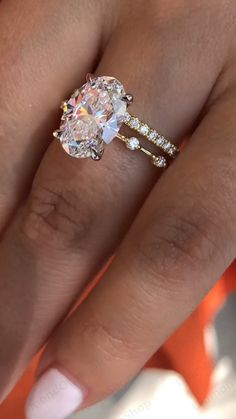 a woman's hand with a ring on it and a diamond in the middle