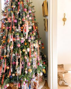 a christmas tree decorated with ornaments and ribbons